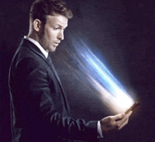 a man in a suit and tie is looking at his phone