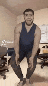 a man with a beard is standing on one leg in a room .