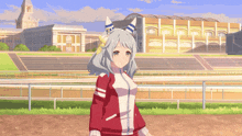 a girl in a red jacket is standing in front of a building
