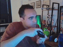 a man is playing a video game with a controller in his hands .
