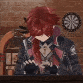 a man with red hair is sitting in front of a dartboard
