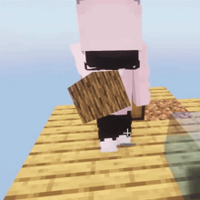 a person in a pink shirt with the letter l on it is holding a wooden block