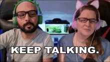 a man and a woman wearing headphones and cat ears say keep talking ..