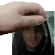 a hand is touching a man 's face in front of a picture .
