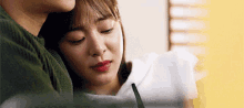 a man and a woman are hugging each other while the woman is crying .