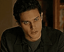 a close up of a man 's face with a serious look on his face .