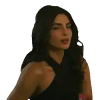 a woman in a black top looks to the side