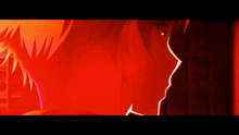 a close up of a person 's face with a red light behind them