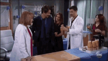 a group of people standing around a table with a sign that says ctn on it