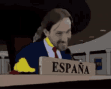 a man in a suit and tie is giving a thumbs up in front of a sign that says espana