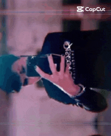 a person is taking a picture of themselves with their phone .
