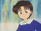 a boy in a blue shirt with a white collar smiles