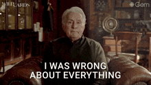 an older man sits in a chair with the words i was wrong about everything behind him