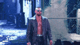a man wearing sunglasses and a leather jacket is walking on a stage