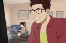 a man wearing glasses is smiling while a woman sits on a couch with a laptop