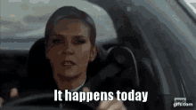 a woman is driving a car and says " it happens today " .