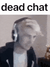 a man wearing headphones and a hat with the words dead chat below him