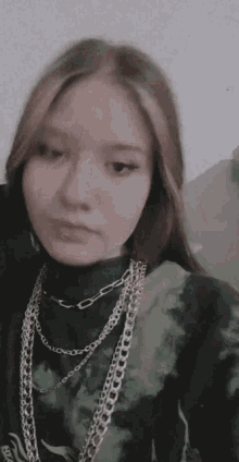 a girl wearing a tie dye shirt and a chain necklace