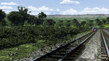 thomas the train is going down train tracks in a lush green forest
