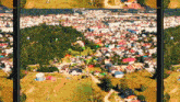 an aerial view of a small town surrounded by trees and houses