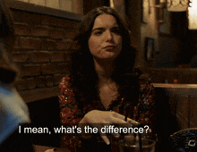 a woman sitting at a table talking to another woman with the words i mean what 's the difference