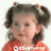 a blurry picture of a little girl with a star tamil chat logo