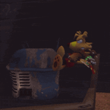 a stuffed animal is sitting on a shelf next to a trash can