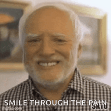 an older man with a beard and mustache is smiling and says `` smile through the pain '' .