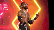 a wrestler wearing sunglasses is pointing at something