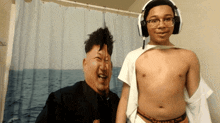 a boy wearing headphones stands in front of a shower curtain that has a picture of kim jong un on it