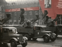 a row of military vehicles are parked in front of a red banner that says ' soviet union '