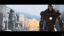 a man in a iron man suit is standing in front of a city .