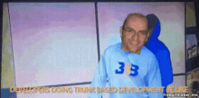 a man wearing a blue shirt that says 333 on it