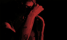a man in a red shirt is screaming with his mouth open