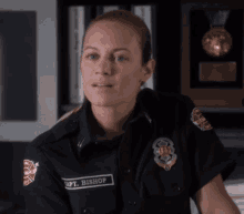a woman in a firefighter uniform has the name bishop on her uniform