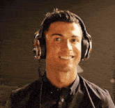 a man wearing headphones and a shirt that says cr7 is smiling