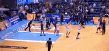 a basketball game is being played on a court that has a pizza hut ad