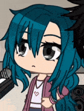 a girl with blue hair is standing in front of a microphone and a speaker