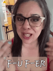 a woman wearing glasses says f-u-f-er in front of her face