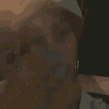 a close up of a woman 's face with a blurred background