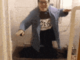 a person wearing a shirt that says cdk is standing in front of a bathtub