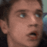 a blurry picture of a man 's face with his mouth open