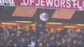 a crowd of people watching a soccer game with the score gro 1-0 hee