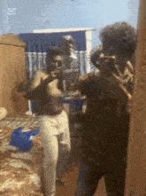 a shirtless man is taking a picture of himself in a mirror with the letter d on the bottom