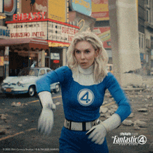 a woman in a fantastic four costume is running down a street