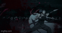 a woman in a bloody dress is standing in front of a group of people in a dark room .