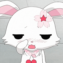 a white rabbit with pink ears and a pink flower on its head