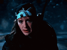 a man wearing a bandana and a hat holds a sword