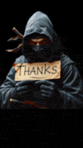 a person with a hood on their head is standing in a dark room