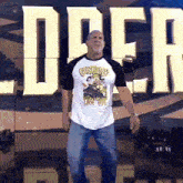 a man in a cowboys shirt is standing in front of a sign